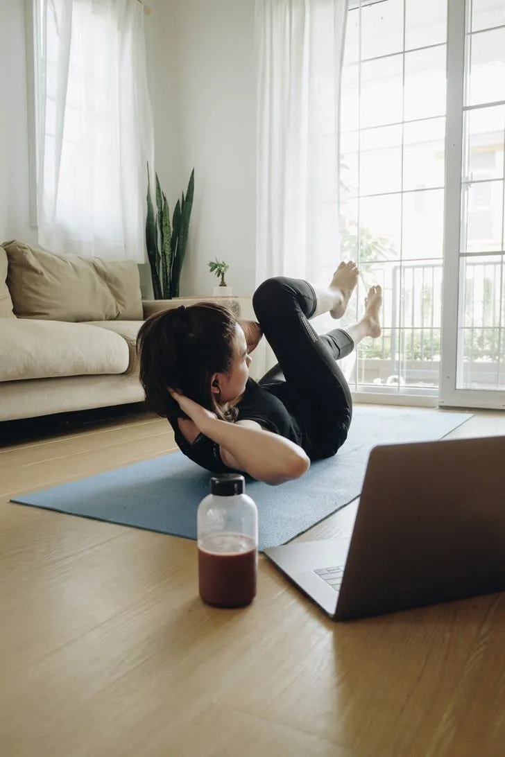 Person performing a gentle stretch near a window